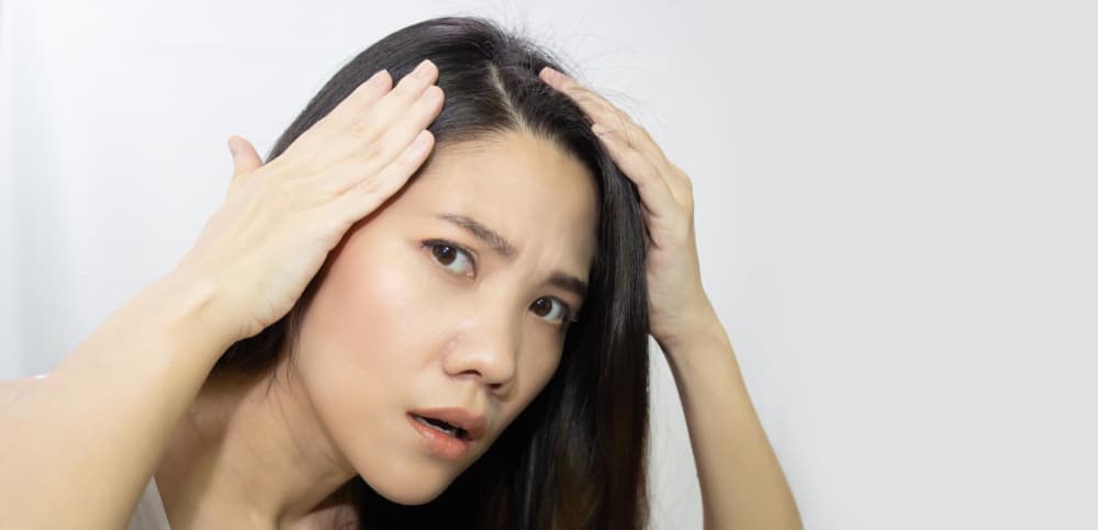 asian-beautiful-woman-use-hand-touch-her-head-and-looking-to-check-grey-hair-with-a-worry-face (1)